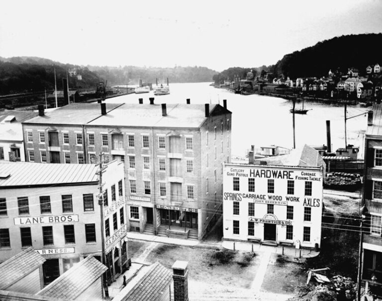 A black and white photograph of Norwich's riverfront businesses.