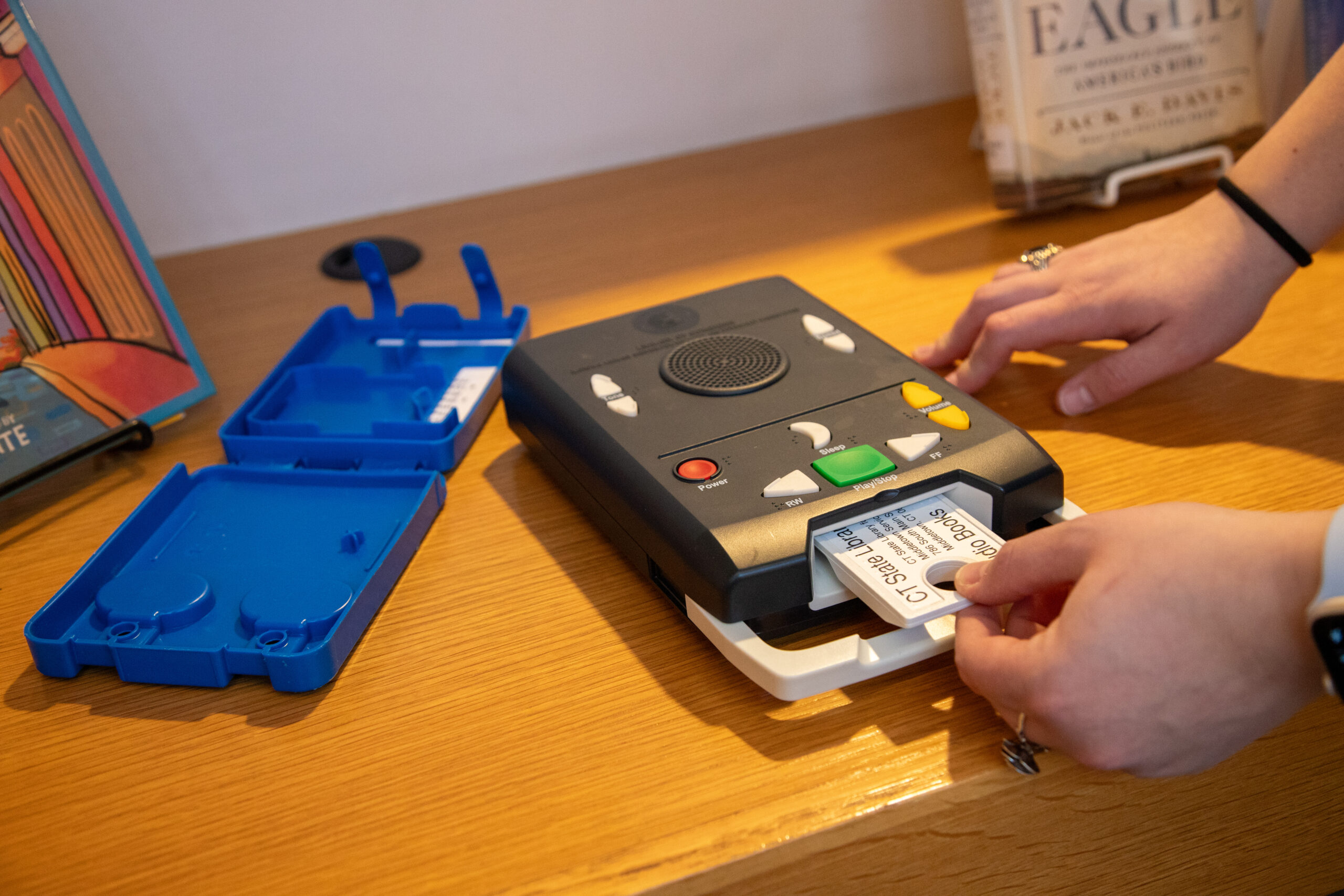 The Talking Book player is easy to use with color coding, visual labels, and raised symbols.  One cartridge can store up to 12 books on it!