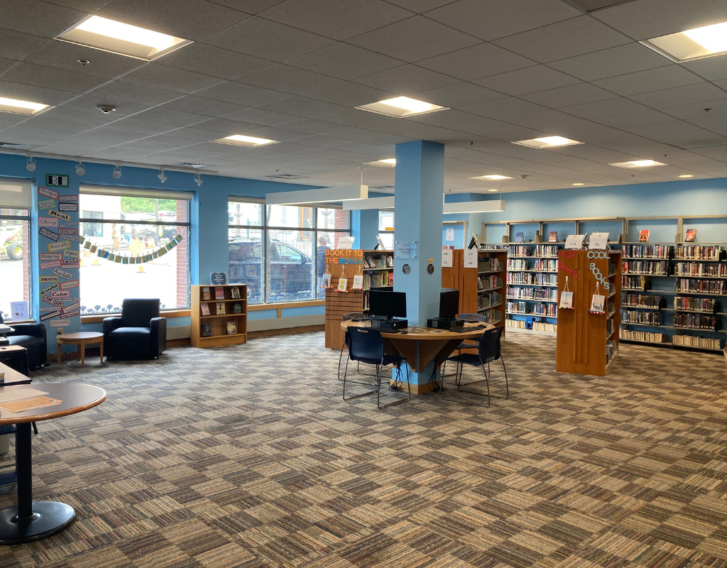 Image of the YA area, showcasing the shelves, sitting area, and computers