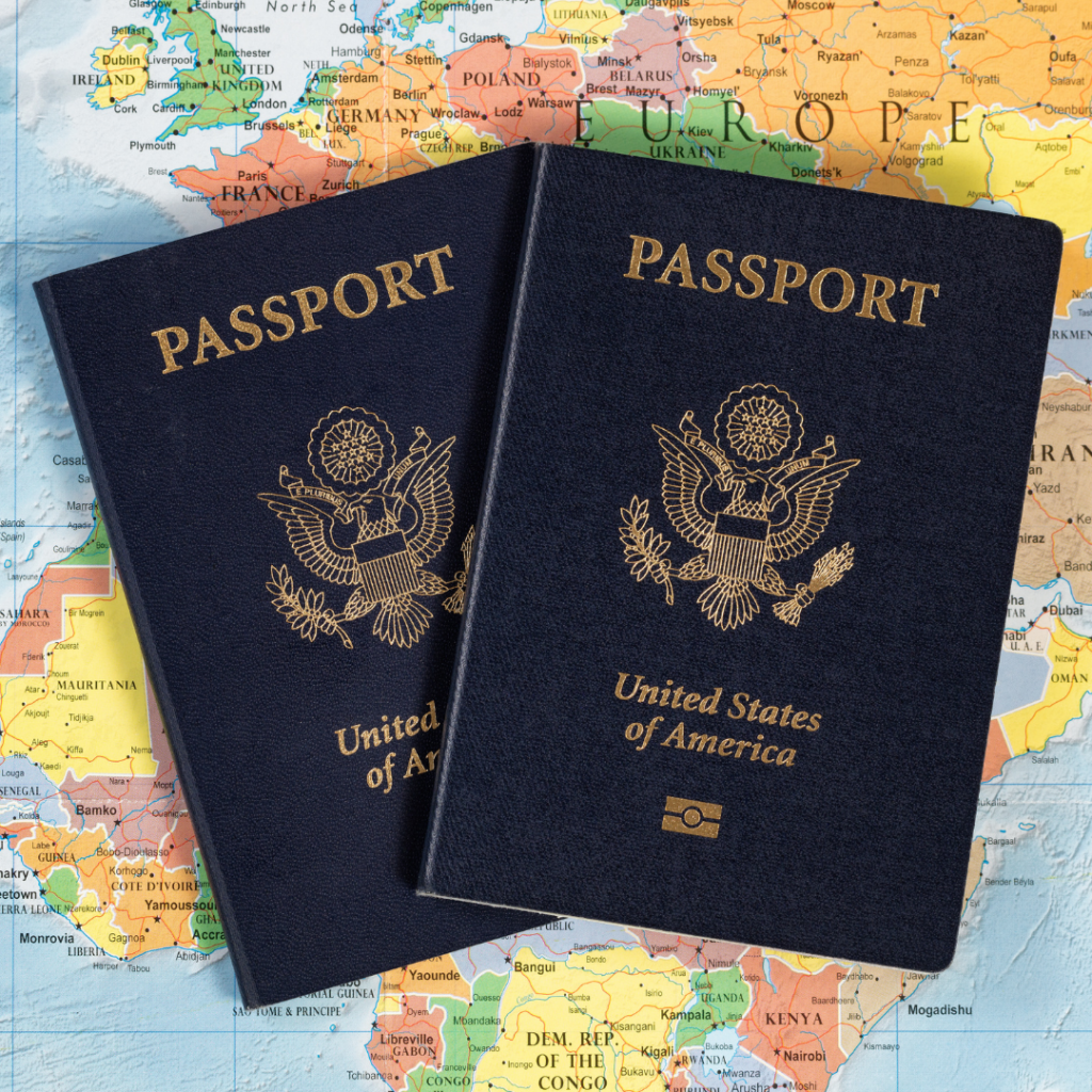 Two U.S. Passports are gently laid against a world map.