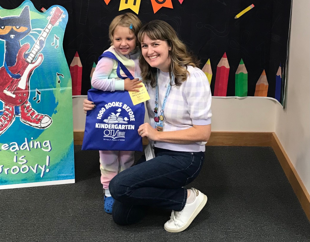 Miss B and a reader celebrate having read 1000 books before kindergarten.